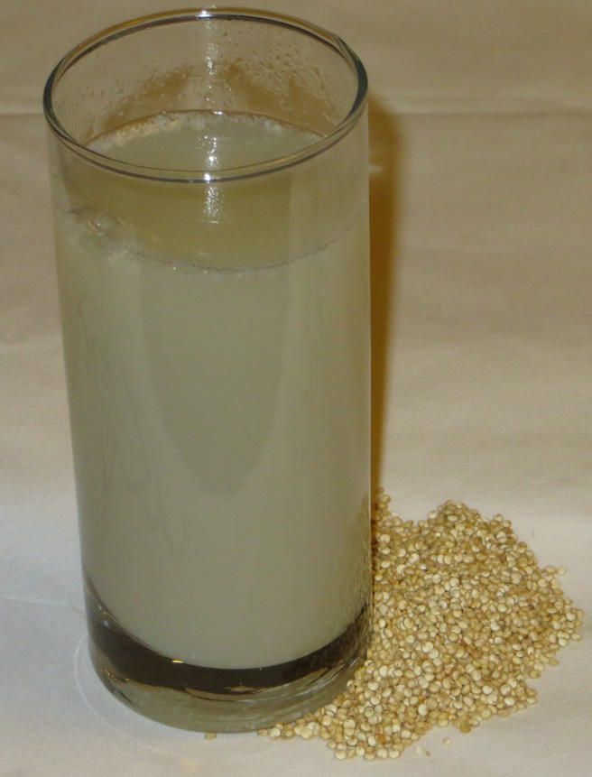 Glass of quinoa milk and quinoa grains